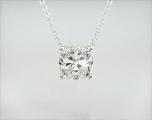 This light four prong wire basket is designed to showcase the unique characteristics of the cushion shaped diamond of your choice. This lovely solitaire pendant is attached to an 18" cable link chain. Truly a classic design that is perfect for any occasion. Center diamond or gemstone purchase required