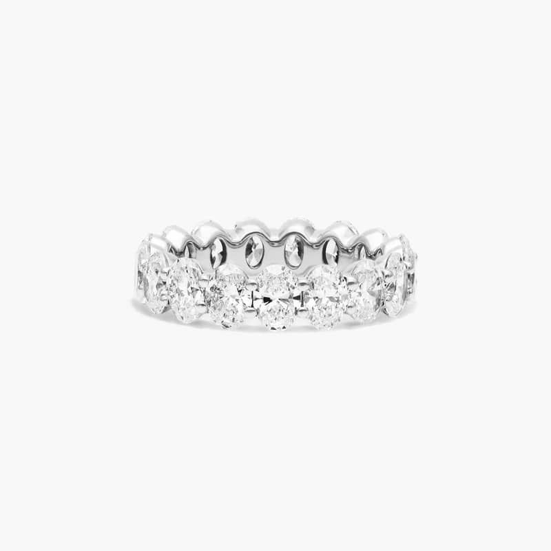 This timeless eternity ring features the boldness and intense sparkle of oval cut diamonds. A classic, tailored shared prongs setting allows the maximum amount of the diamonds surface to show. *Number of diamonds and carat total weight will vary depending on ring size.