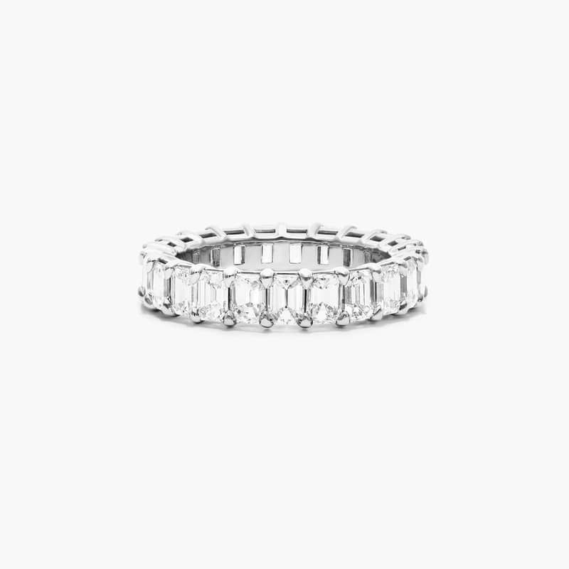 This timeless eternity ring features the boldness and elegant gleam of emerald cut diamonds. A classic, tailored shared prongs setting allows the maximum amount of the diamonds surface to show. *Number of diamonds and carat total weight will vary depending on ring size.