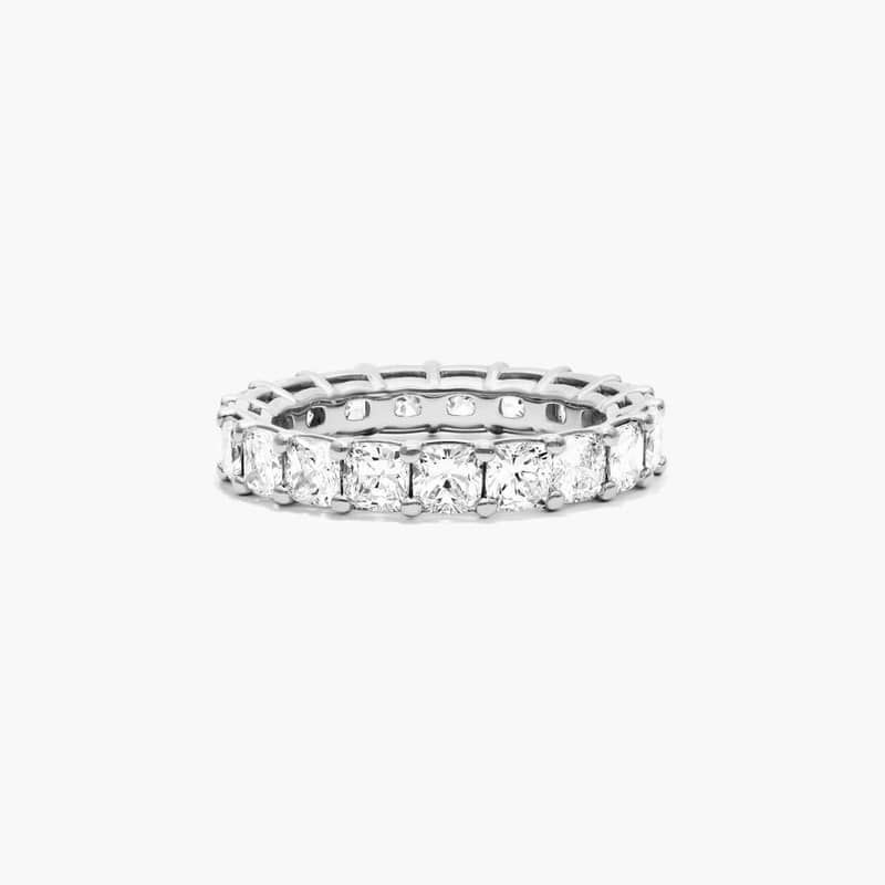 This timeless eternity ring features the boldness and intense sparkle of cushion cut diamonds. A classic, tailored shared prongs setting allows the maximum amount of the diamonds surface to show. *Number of diamonds and carat total weight will vary depending on ring size.