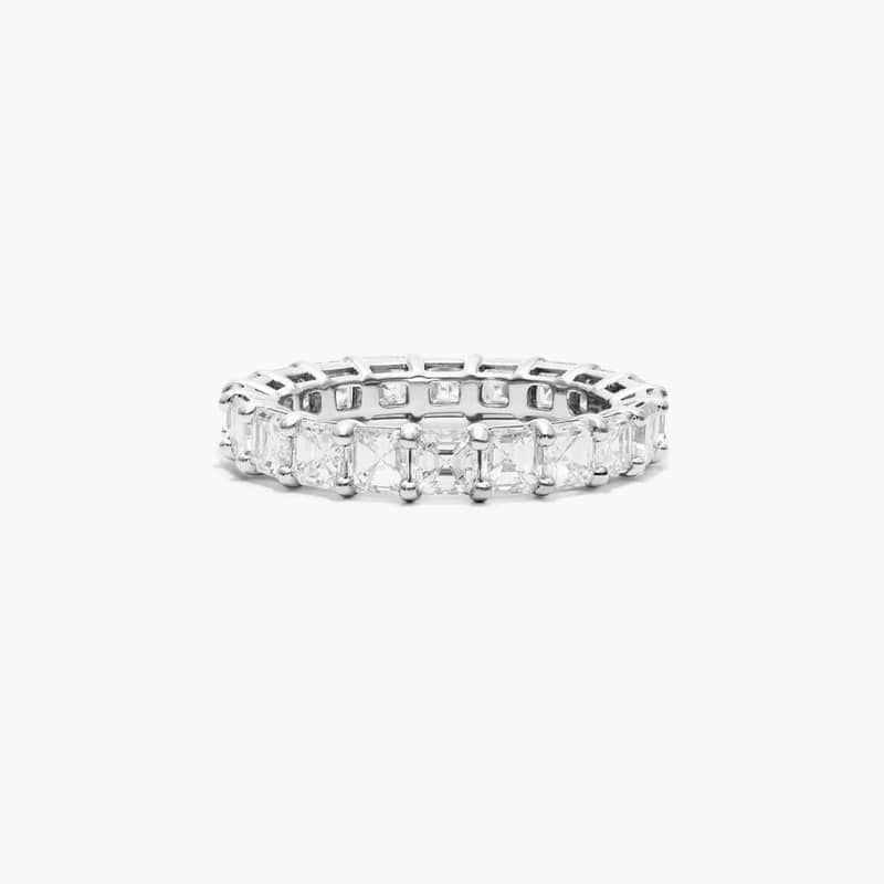 This timeless eternity ring features the boldness and elegant gleam of asscher cut diamonds. A classic, tailored shared prongs setting allows the maximum amount of the diamonds surface to show. *Number of diamonds and carat total weight will vary depending on ring size.