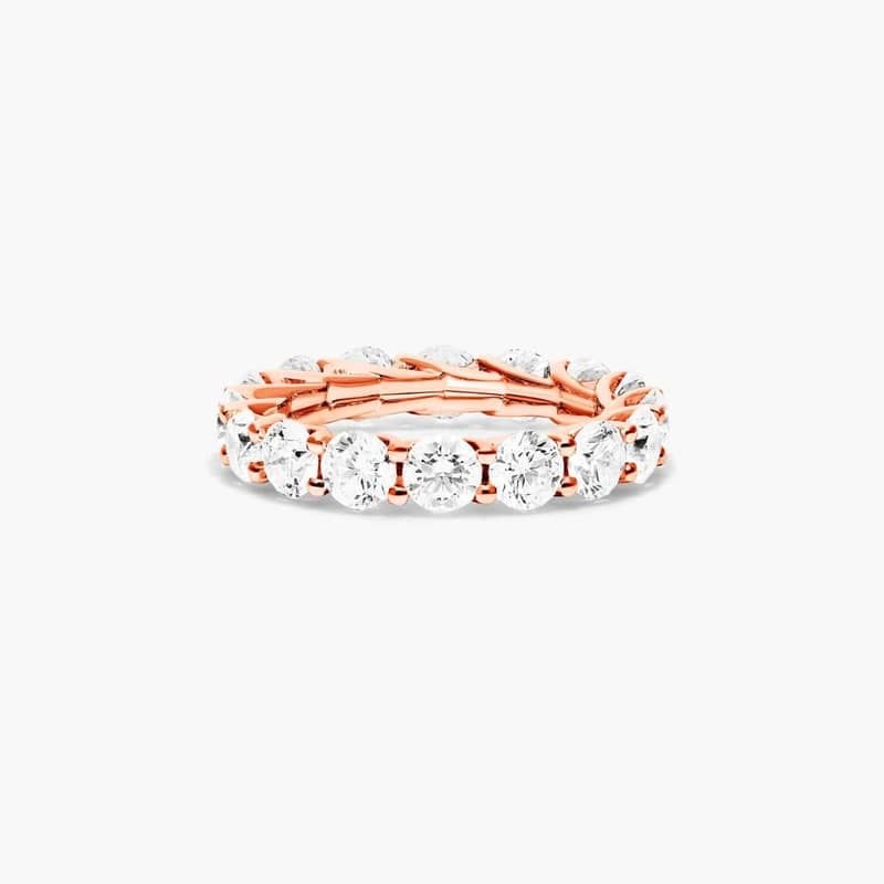 Slender prongs cross over one another endlessly to weave elegant trellis baskets. This finely crafted setting features a striking side profile that will only enhance the beauty of the round brilliant diamonds. *Number of diamonds and carat total weight will vary depending on ring size.