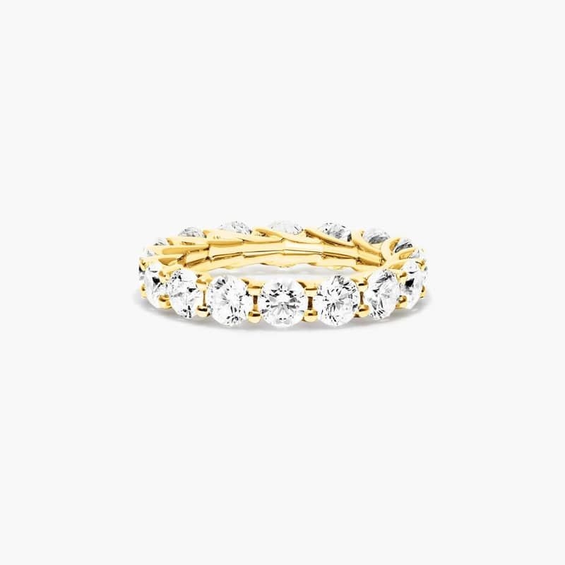 Slender prongs cross over one another endlessly to weave elegant trellis baskets. This finely crafted setting features a striking side profile that will only enhance the beauty of the round brilliant diamonds. *Number of diamonds and carat total weight will vary depending on ring size.