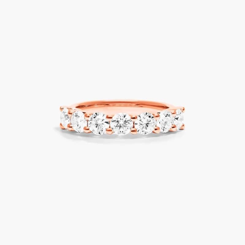 Slender prongs cross over one another to weave elegant trellis baskets. This finely crafted setting features a striking side profile that will only enhance the beauty of seven lab created round brilliant diamonds.