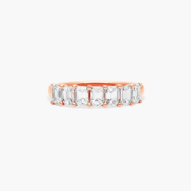 This timeless seven stone anniversary ring features the boldness and elegant gleam of emerald cut diamonds. A classic, tailored shared prongs setting allows the maximum amount of the diamonds surface to show.