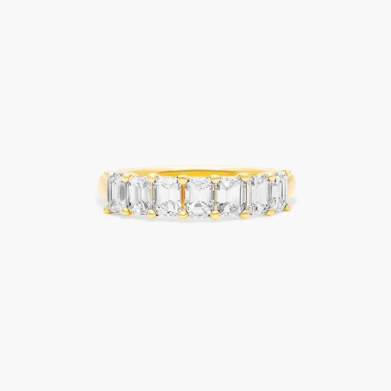 This timeless seven stone anniversary ring features the boldness and elegant gleam of emerald cut lab created diamonds.  A classic, tailored shared prongs setting allows the maximum amount of the lab created diamonds surface to show.
