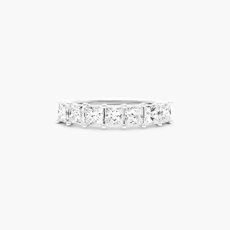 This timeless seven stone anniversary ring features the boldness and intense sparkle of princess cut diamonds. A classic, tailored shared prongs setting allows the maximum amount of the diamonds surface to show.