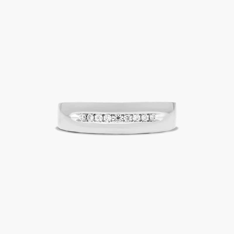A row of nine diamonds is displayed in a channel setting and a high polished 5.7 mm band that tapers on the back for added comfort.