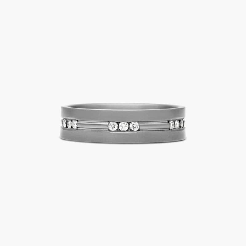 This sleek design features clean lines combined with channel set diamond stations across the center of the ring.