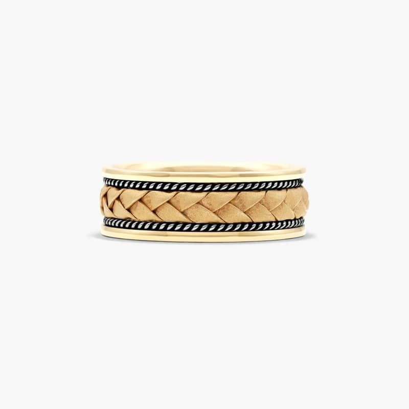 The mix of patterns makes this yellow gold ring modern and eclectic. A hand crafted braid center is framed by white gold twisted cables and high polished edges.