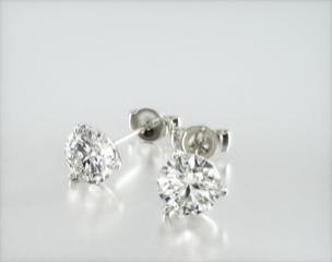 These three-prong martini setting is constructed to fit the exact size of the diamonds used. The diamonds sit perfectly flush into the setting; exactly as the Martini design was intended. Screw backs are available for an additional $125. Center diamonds or gemstones purchase required