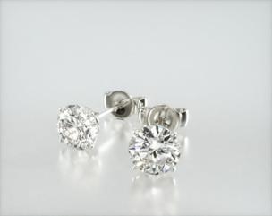 Timeless and stunning, round diamond stud earrings add a classic elegance to any occasion. Made with standard friction back posts. Available in screw backs for an additional $125. (Center Diamonds are sold separately) Center diamonds or gemstones purchase required