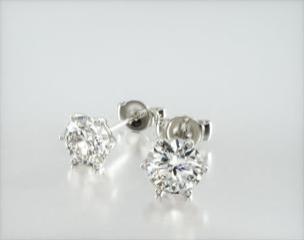 This design is elegant and timeless, made to accent the beauty of the round brilliant diamond of your choice with slender wire prongs and rolled wire basket. This earring will fit slightly off the ear and features friction backs. Center diamonds or gemstones purchase required