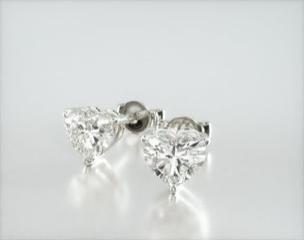 This pair of dazzling heart shape diamond stud earrings are the perfect token to symbolize your everlasting love. Set in elegant, light-weight baskets these heart shape diamond of your choice make the perfect match. Center diamonds or gemstones purchase required
