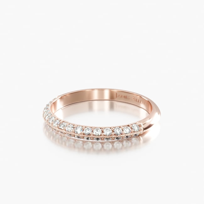 The timeless appeal of a knife edge pavé wedding ring with a feminine and charming profile. Perfect alone, stacked accompanying the lotus flower basket engagement ring.
