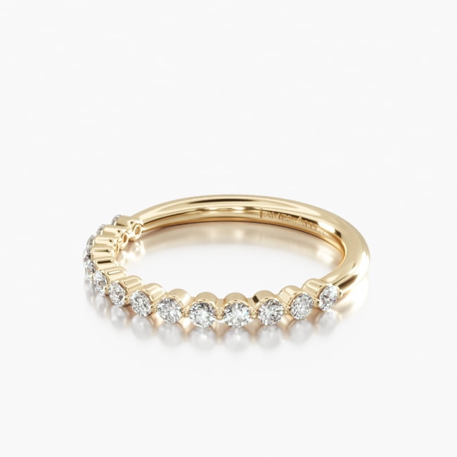 The common prong settings reveal the outline of the diamonds and allow light to pass through creating a row of uninterrupted brilliance