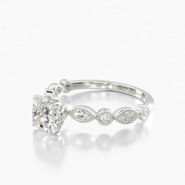 Take the mystic appeal of a magnificent marquise shape diamond and couple it with round brilliant diamonds and you are sure to cause a sensation with this ring. Milgrain details compliment this timeless engagement ring.