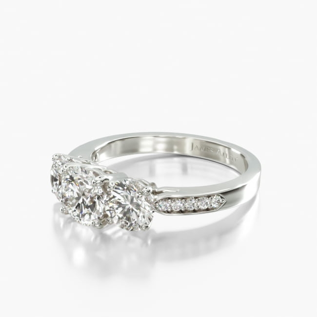 This classic three stone round shaped ring features a little extra shimmer with Pavé set diamonds in the shank. This ring has a design that will be treasured for a lifetime.