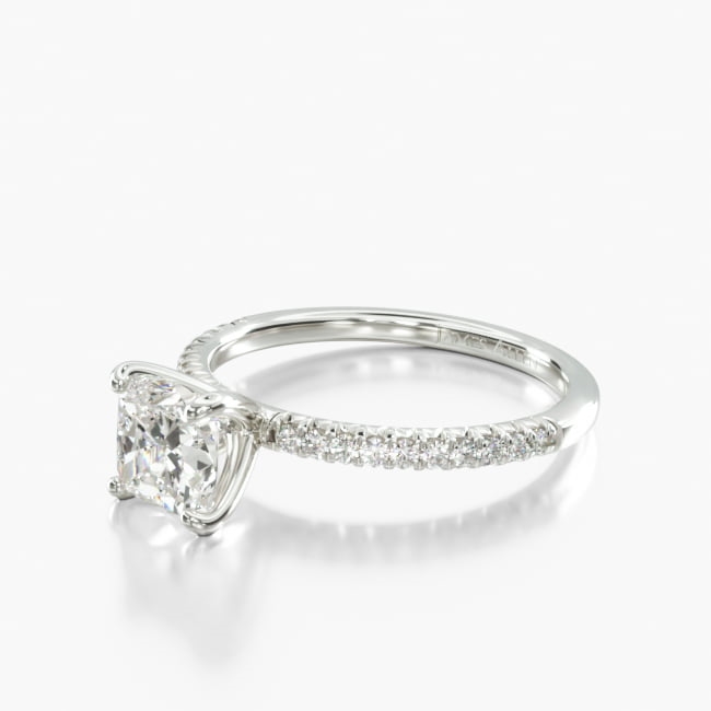 This French Cut Pavé diamond engagement ring is created to maximize the amount of light that hits the diamonds from all sides, set with a small v shape under the diamond, increasing their individual sparkle. The custom tailored prongs are set into the shank of the ring, allowing a variety of bands to sit flush with the engagement ring.