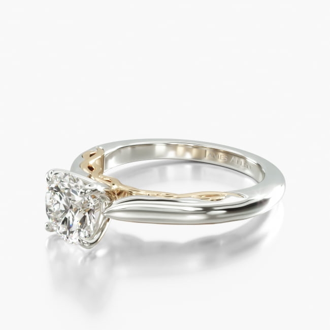 Take inspiration from the delicate patterns of Celtic knots with this gorgeous two toned solitaire engagement ring. The twisting yellow gold detail acts as a graceful contrast against the beautifully smooth white gold band. Pair this with the matching band for a remarkable set.