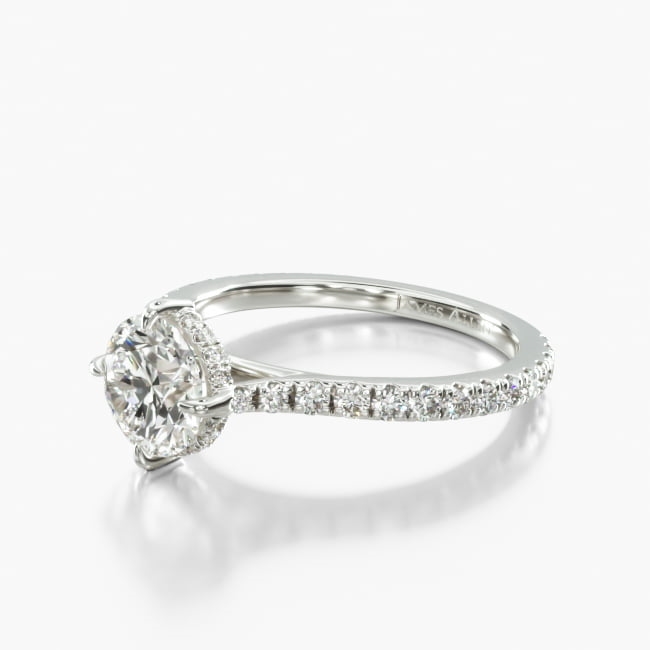 This eye catching engagement ring holds the center stone with north, south, east, west claw prongs in a diamond embellished setting. This thoughtful design features shimmering diamonds on the shank to complement the luxurious look.
*Number of diamonds and total carat weight listed on the product information is based on a 1 ct. round center stone. Please note that the number of diamonds and total carat weight may vary according to the size and shape of the center stone.