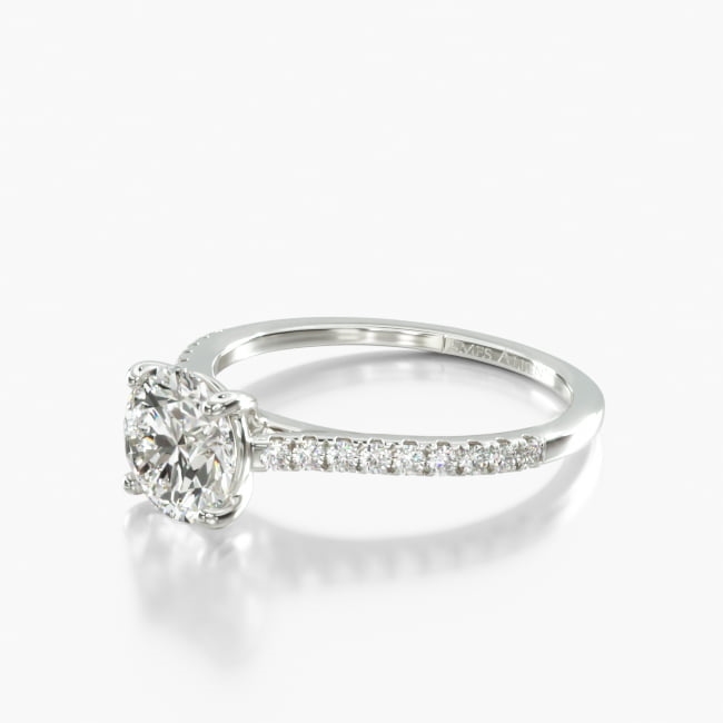 Classic style with the ultimate sparkling twist. A row of stunning diamonds rise into the cathedral shank, to raise and highlight the center stone. Allowing the ring to shine so bright it will take everyone's breath away.