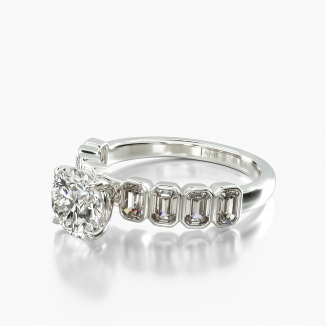 This simple yet unique ring features beautiful emerald cut diamonds within a secure bezel setting to perfectly compliment the center diamond of your choice.