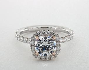 The French pavé u style of this engagement ring setting allows the maximum amount of light to travel through the diamonds and enhance the cushion center stone of your choice. The single row of pavé diamonds in the halo will contour to fit the exact shape of the diamond or gemstone you select, and the rose gold claw prongs provide a pop of color to add contrast. pavé accents and a rose gold scroll design in the undergallery create a unique aesthetic when the setting is viewed from the side.
