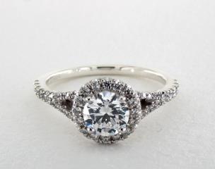 This stunning diamond engagement ring features round brilliant cut diamonds in a halo around the center stone of your choice. Round brilliant cut pavé set diamonds adorn the classic split shank for a tailored look.